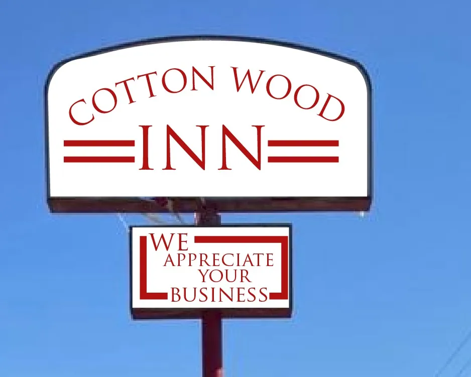 Cotton Wood Inn pylon sign in red and white with a secondary panel below