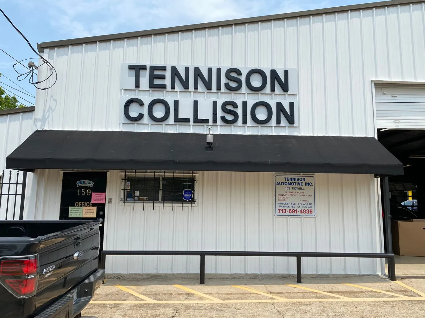 Tennison Collision dimensional black letters mounted on a white building